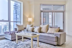 a living room with a couch and a table at 2BR High Floor Torch Tower Dubai Marina in Dubai