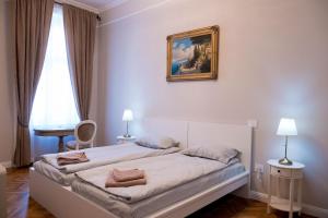 1 dormitorio con 1 cama con una pintura en la pared en Apartament Alma, en Timisoara