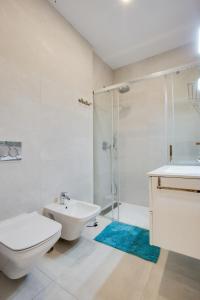 a bathroom with a toilet and a sink and a shower at ICEBERG LUXURY TARIFA ***** in Tarifa