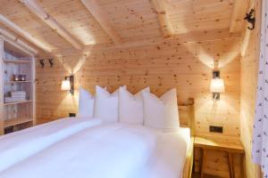 a bedroom with a bed in a wooden room at Chalet Berghaus Gauertal in Schruns-Tschagguns