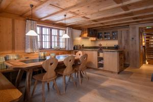 a kitchen with a large wooden table and chairs at Chalet Berghaus Gauertal in Schruns-Tschagguns