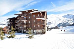 a building on top of a snow covered mountain at Mottaret in Méribel