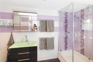 a woman taking a picture of a bathroom with a shower at Casa Teutoburgia in Herne +27 photos