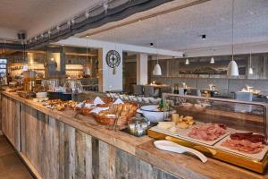 a buffet line with meats and other foods on display at Ciasa Verena in Corvara in Badia