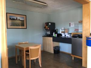 a kitchen with a table and a small table and a counter at Tiki Lodge in Medford