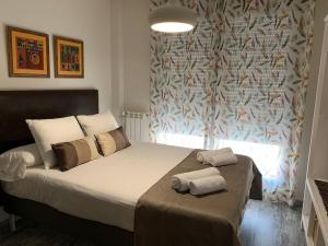 a bedroom with a bed with two towels on it at APARTAMENTO ALEGRIA CENTRO in Albacete