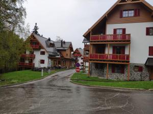 an empty street in a village with a house at Antela appartments for up to 5 person on Mariborsko Pohorje in Pohorje