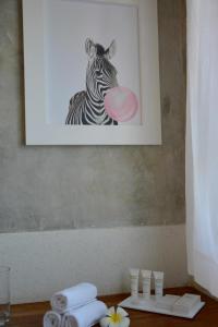 a picture of a zebra with a pink frisbee at Amani Residence Beverly Suites in Malindi