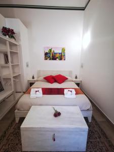 a bedroom with two beds with red pillows at Etesia Vacation Home in Acitrezza
