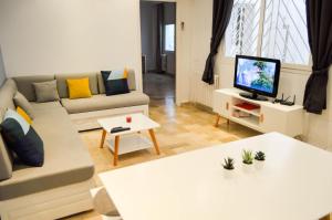 a living room with a couch and a tv at Cosy apartment @ La marsa Corniche-Beach in La Marsa