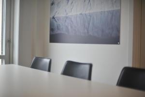una sala de reuniones con una mesa y sillas blancas en Nuuk City Hostel, en Nuuk