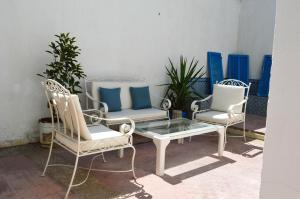 two chairs and a coffee table on a patio at Cosy apartment @ La marsa Corniche-Beach in La Marsa