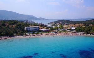 a beach with a large group of people in the water at Your Holiday House in Porto Rafti