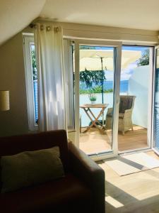 a living room with a couch and a table with an umbrella at Ostseeblick Sassnitz in Sassnitz