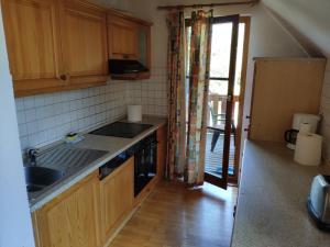 a kitchen with a sink and a stove at Antela, 142 m2 appartment for 12 person in Mariborsko Pohorje in Hočko Pohorje
