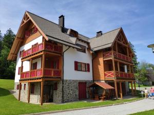 a large wooden house with people standing in front of it at Antela, 142 m2 appartment for 12 person in Mariborsko Pohorje in Hočko Pohorje