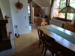 a kitchen with a wooden table and a dining room at Antela, 142 m2 appartment for 12 person in Mariborsko Pohorje in Hočko Pohorje