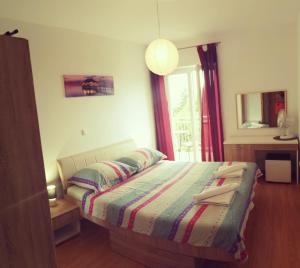 Postel nebo postele na pokoji v ubytování Apartmani Nada
