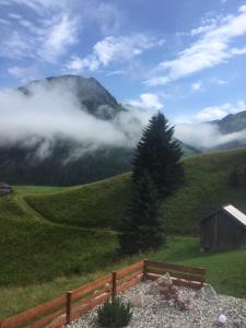 a bench on a hill with a view of a mountain at Mountain Chalet R in Berwang