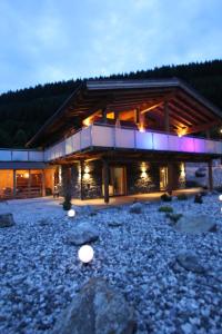 a large log building with lights on the side of it at Mountain Chalet R in Berwang