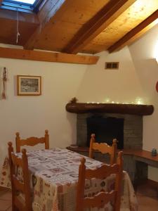 a dining room with a table and a fireplace at Casetta con camino in La Magdeleine