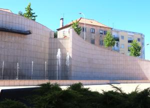 eine Schutzwand mit einem Brunnen vor einem Gebäude in der Unterkunft COLD CITY HOUSE in Guarda