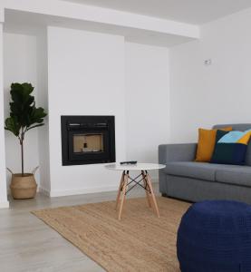 a living room with a couch and a table at COLD CITY HOUSE in Guarda