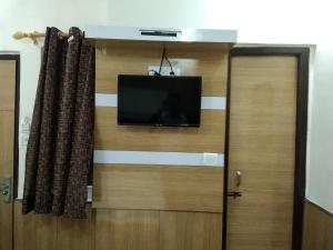 a flat screen tv on a wall in a room at Silver Palace Hotel in New Delhi +58 photos