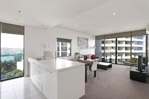 a kitchen and living room with a view of a building at Docklands Private Collection - NEWQUAY in Melbourne