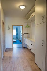 an empty room with white cabinets and a hallway at Apartmán Laura, Frymburk in Frymburk