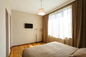 a bedroom with a bed and a window at Brick walls in Gori