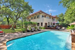 a home with a swimming pool in front of a house at The Lancaster Manor Bed and Breakfast in Gainesville