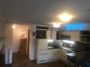 a kitchen with white cabinets and a blue light at FeWo Gretchen in Berchtesgaden
