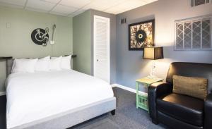 een slaapkamer met een bed en een stoel bij Music Valley Studio - No Fees - Opryland Area in Nashville