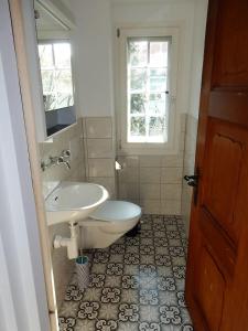 a bathroom with a sink and a toilet and a sink at Traditional Swiss-Flat in Interlaken +26 photos