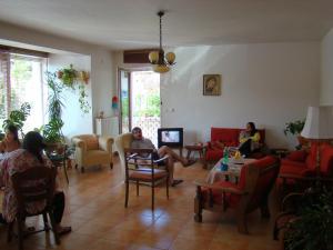 a group of people sitting in a living room at Pension Charlie Retro-Modern Design in Prague