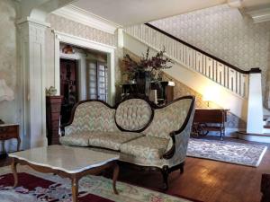 sala de estar con sofá y mesa en The Lancaster Manor Bed and Breakfast en Gainesville