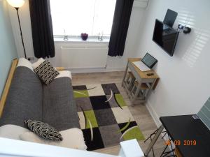 a living room with a couch and a table at The Whiteways in Bristol