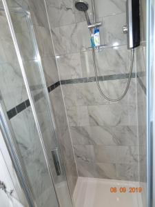 a shower stall with a glass door and a shower constructor at The Whiteways in Bristol +22 photos