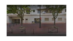 a building with trees in the middle of a street at DREAM Flat in PARIS in Levallois-Perret