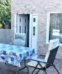 a table and a chair on a patio at Villa Milka in Utjeha