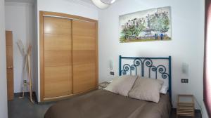 a bedroom with a bed and a large wooden closet at Villa Rural El Mirador in Alora +47 photos