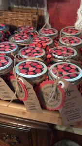 a bunch of red hearts in jars on a table at The Lancaster Manor Bed and Breakfast in Gainesville