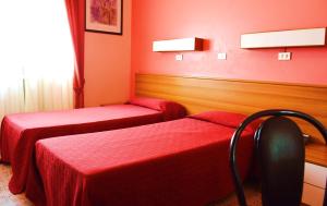 Postel nebo postele na pokoji v ubytování Hotel Rosy