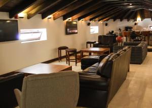 a bar with leather couches and tables and chairs at Casa San Miguel Hotel Boutique y Spa in Zacatlán