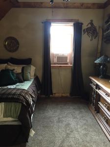 a bedroom with a bed and a window at The Old Church B&B in Warner