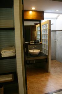 a bathroom with a sink and a shower at Palita Lodge - SHA Plus in Haad Rin
