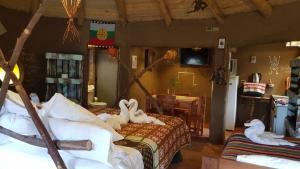 a bedroom with two beds with towels on them at Cabañas Rukas Licantén in Licantén