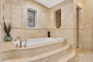 baño grande con bañera y ventana en Villa D' Citta, en Chicago