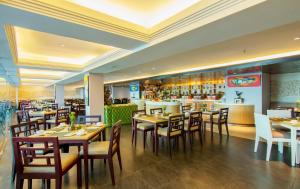 een restaurant met tafels en stoelen en een bar bij Bintang Kuta Hotel in Kuta